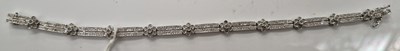 Lot 40E - A 9ct white gold diamond chip set bracelet, 18....