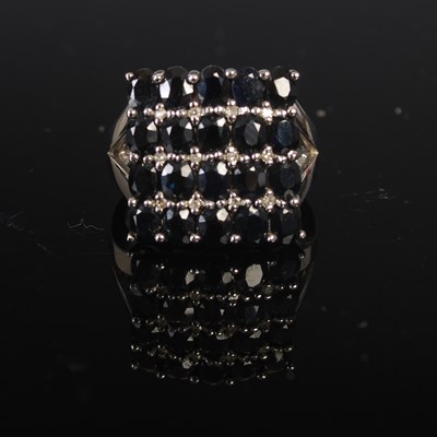 Lot 208M - A 9ct white gold twenty stone sapphire and...