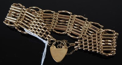 Lot 210N - A 9ct gold gatelink bracelet with 9ct gold...