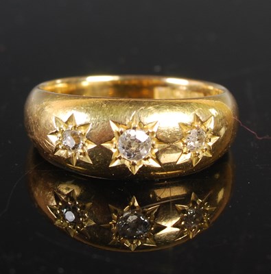 Lot 84 - An 18ct gold and diamond three-stone ring,...