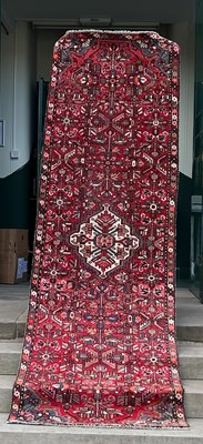 Lot 914 - A 20th century Persian runner, the madder...