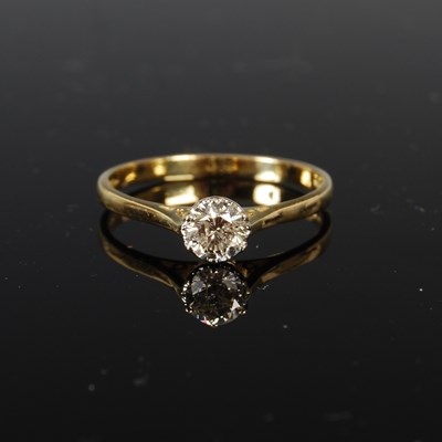 Lot 440 - An 18ct gold and diamond solitaire ring, the...