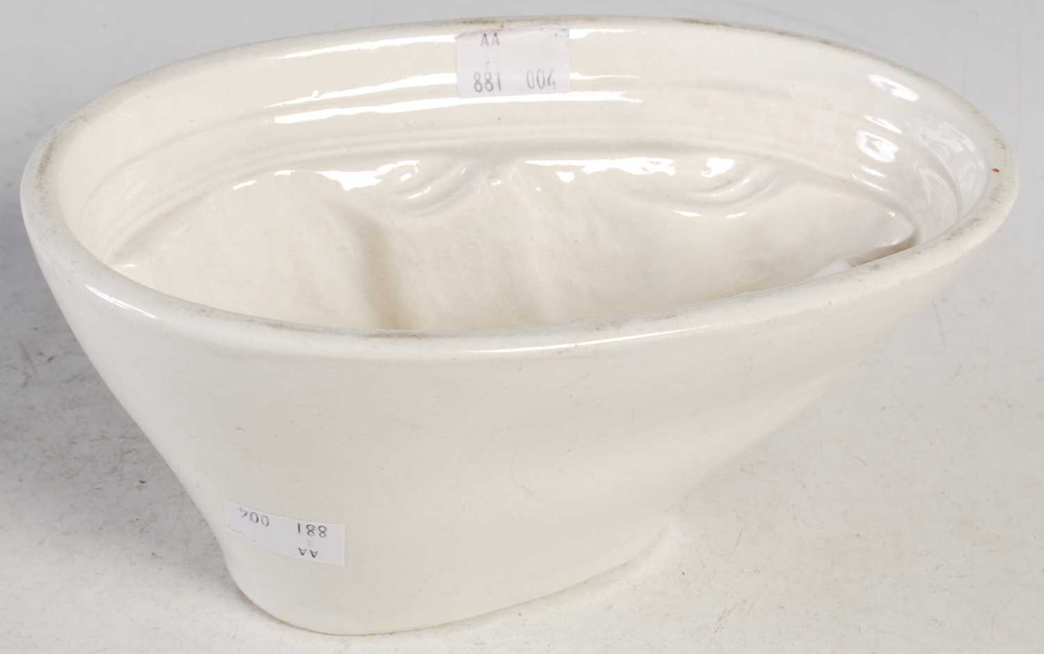 Lot 17 - A 19th century pottery jelly mould forming a...