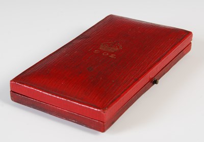 Lot 77 - A group of three medals to include red leather...