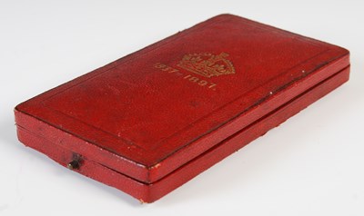Lot 77 - A group of three medals to include red leather...