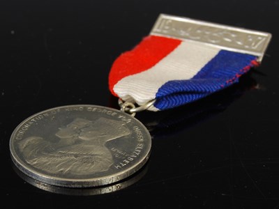 Lot 77 - A group of three medals to include red leather...