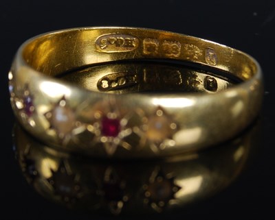 Lot 50 - An 18ct gold split pearl and garnet five stone...