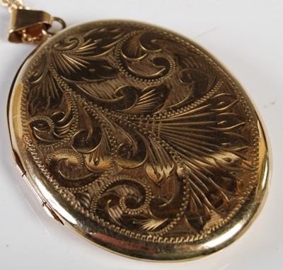 Lot 54 - A 9ct gold oval-shaped locket suspended on...
