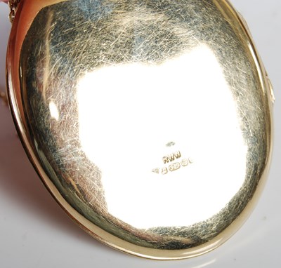 Lot 54 - A 9ct gold oval-shaped locket suspended on...