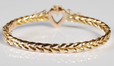 Lot 58 - A yellow metal and split pearl hinged bangle...