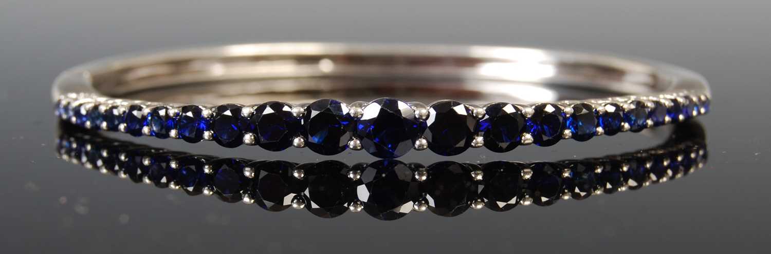 Lot 43 - A white metal and synthetic sapphire single...