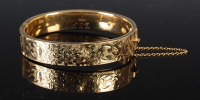 Lot 220 - A 9ct gold hinged bangle, 18.3grams.
