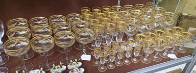 Lot 20 - A part suite of clear and gilded glassware,...