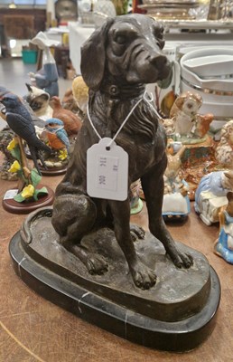 Lot 558 - A 20th century bronze figure of a seated dog,...