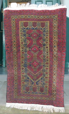 Lot 848 - A Persian madder ground prayer rug, the...