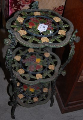 Lot 766 - A polychrome decorated cast metal three-tier...