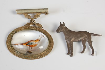 Lot 222 - A white metal brooch in form of a standing dog;...