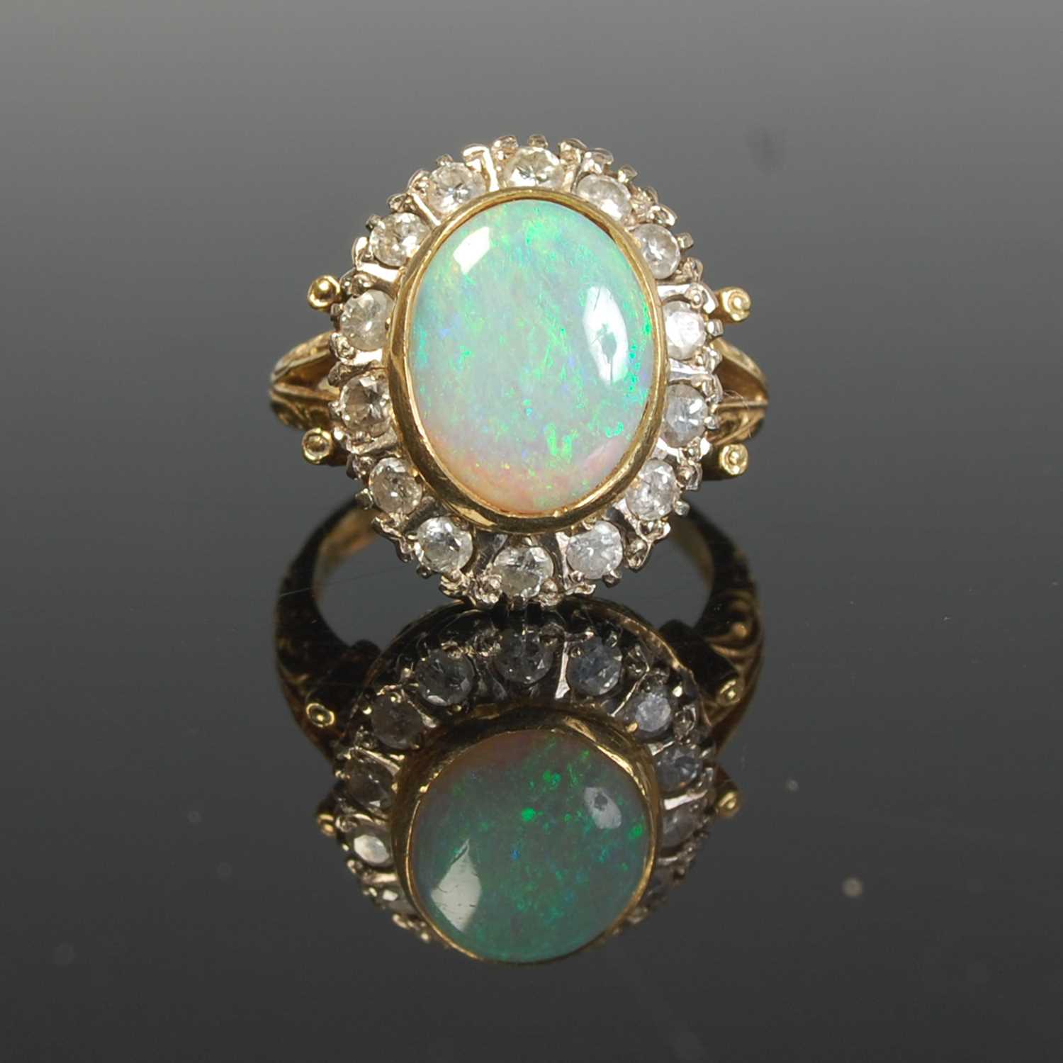 Lot 289 - An 18ct gold, opal and diamond cluster ring,...