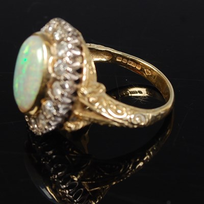 Lot 289 - An 18ct gold, opal and diamond cluster ring,...