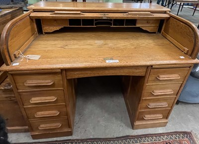 Lot 801 - A vintage blonde oak roll top desk, 116cm wide.