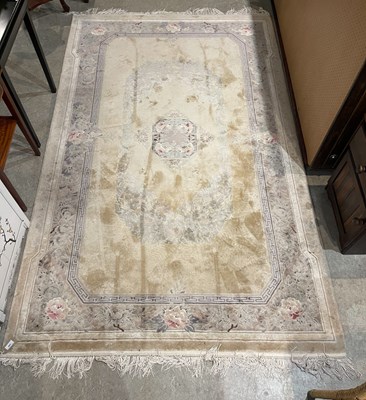 Lot 843 - A Chinese silk rug, the ivory coloured ground...