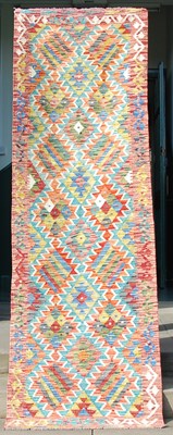 Lot 849 - A Chobi Kilim runner, the madder ground worked...