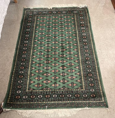 Lot 859 - A 20th century green ground Bokhara type rug,...