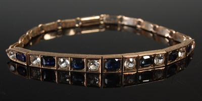 Lot 551 - A yellow metal, colourless and blue sapphire...