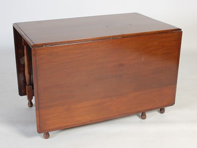 Lot 5 - An early 20th century drop-leaf dining...