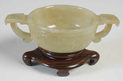 Lot 250 - A Chinese jade Archaic style twin handled cup,...