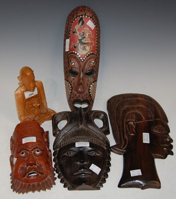 Lot 284 - A group of four carved wall hangings...