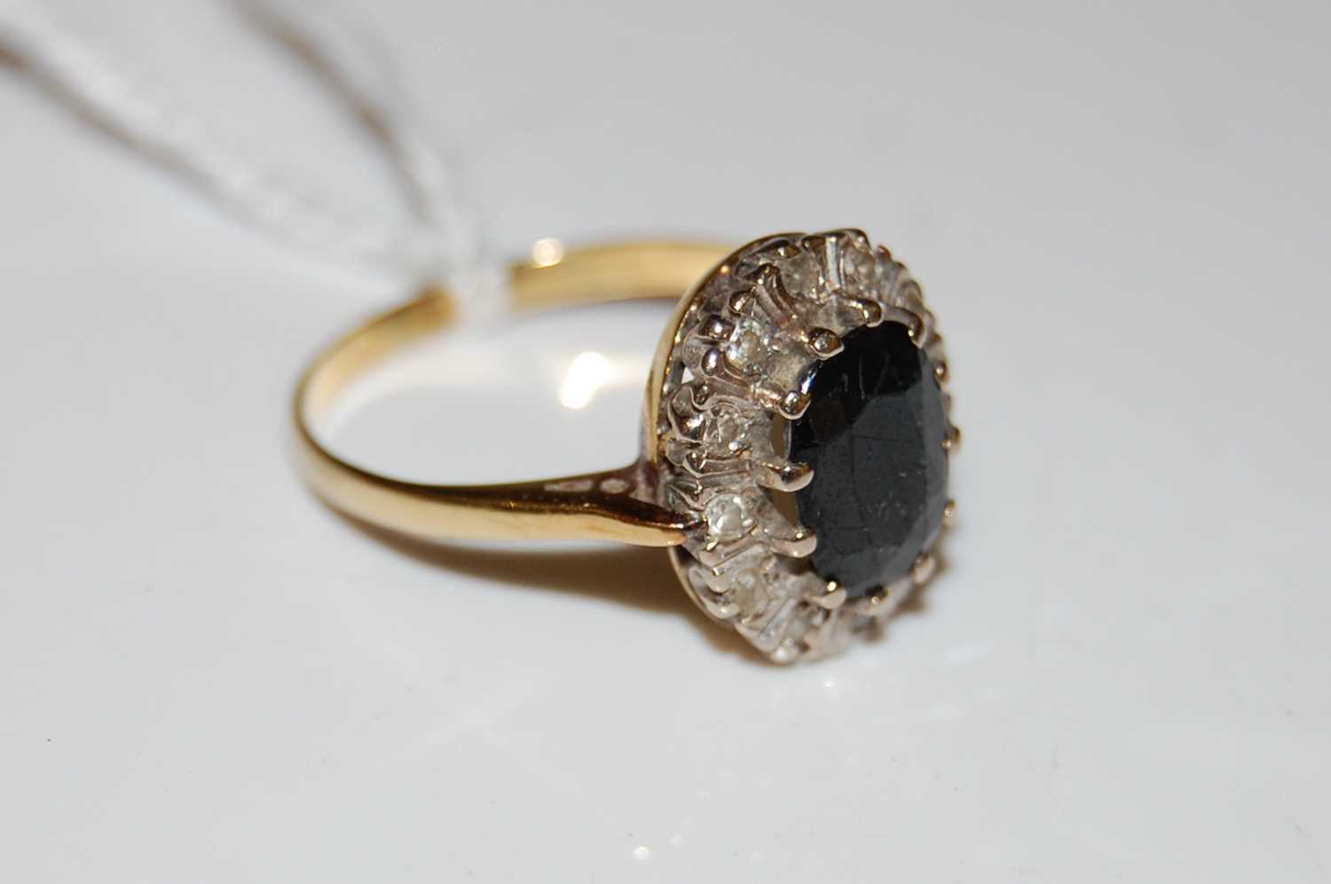 Lot 43 - A yellow metal sapphire and paste set dress ring