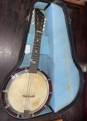 Lot 567 - A vintage banjo, in original case.