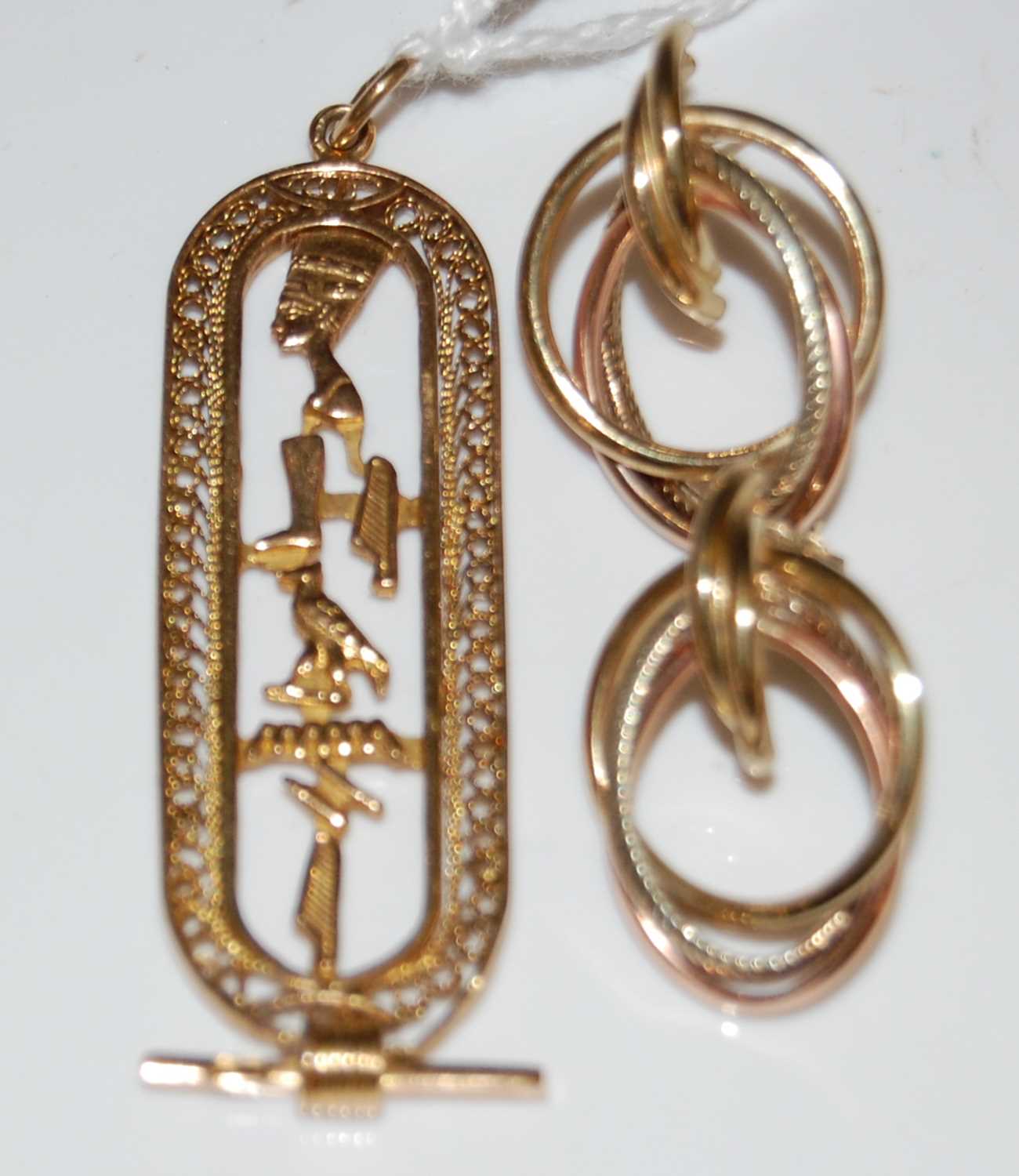 Lot 52 - A yellow metal Egyptian themed pendant, 7.5...