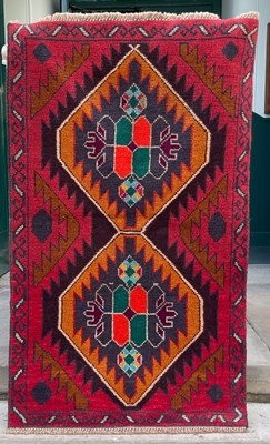 Lot 636 - A Baluchi rug, decorated with two lozenge...