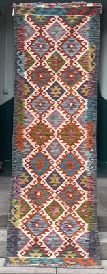 Lot 872 - An ivory ground Chobi kilim runner, the...