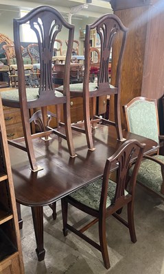 Lot 580 - A dining room suite comprising a mahogany drop-...