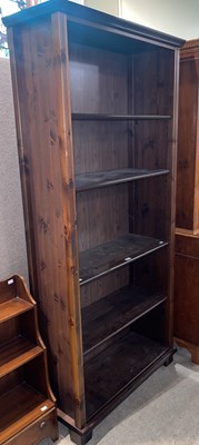 Lot 862 - A modern stained pine open bookcase fitted...