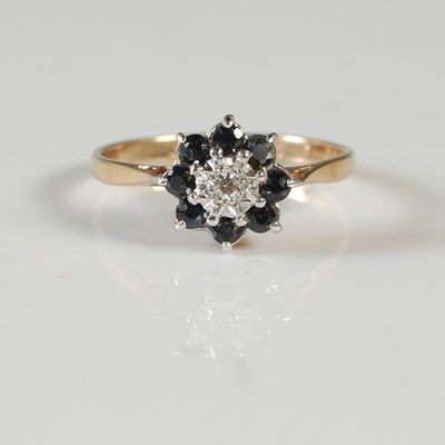Lot 74 - A 9ct gold, sapphire and diamond cluster ring,...