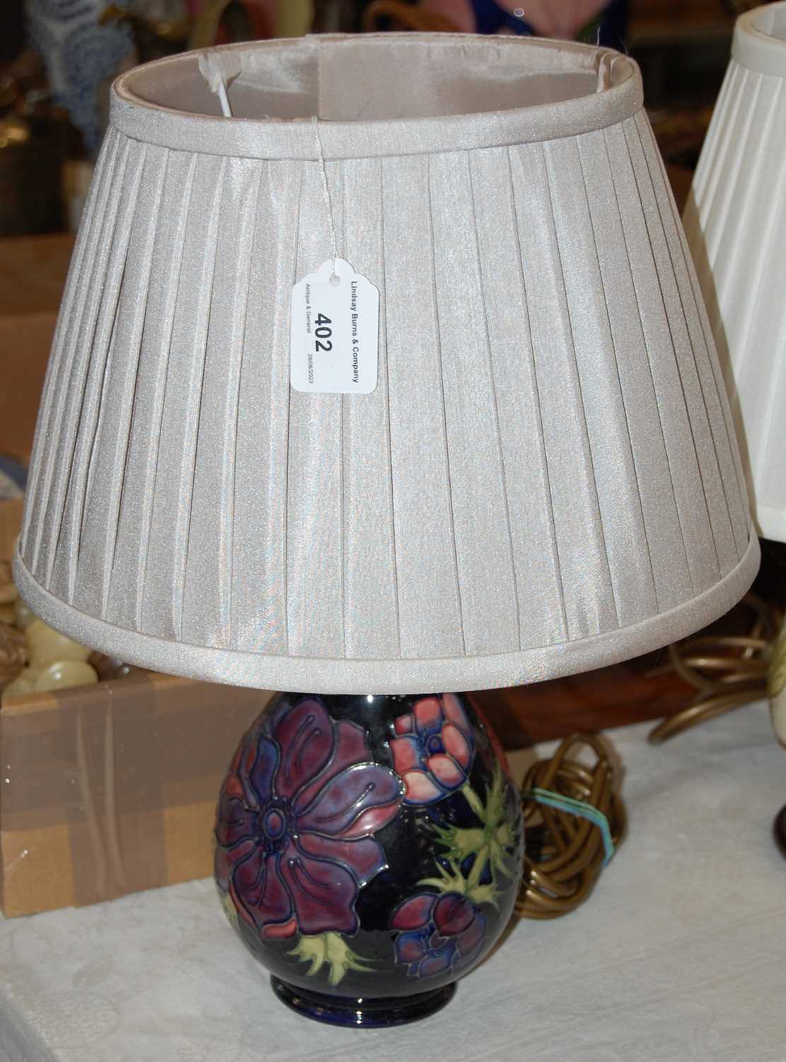 Lot 402 - A Moorcroft table lamp, the blue ground...