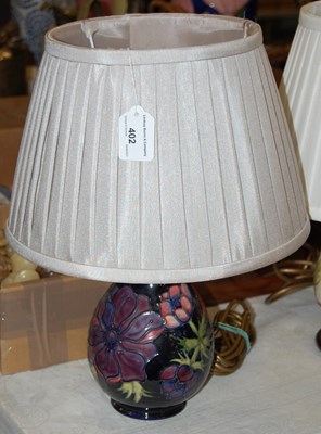 Lot 402 - A Moorcroft table lamp, the blue ground...