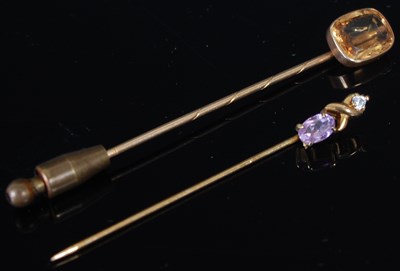 Lot 235 - A gold and oblong topaz tie pin; and an...