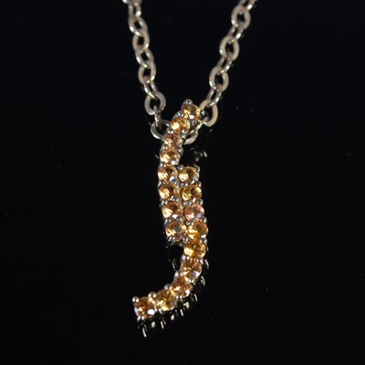 Lot 49 - A yellow metal gem set pendant and chain, the...