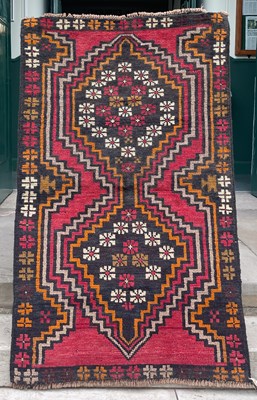 Lot 773 - A Baluchi rug, the madder ground decorated...