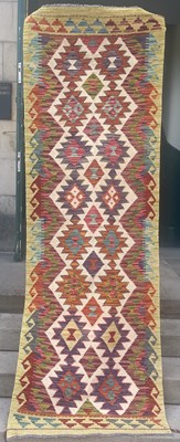 Lot 740 - A Chobi Kilim runner, the ivory coloured...
