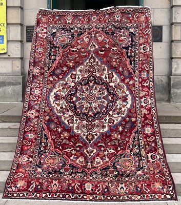 Lot 733 - A Persian Bakhtiari carpet, the madder ground...