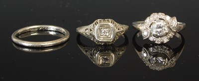 Lot 301 - A white metal and diamond cluster ring, size M,...