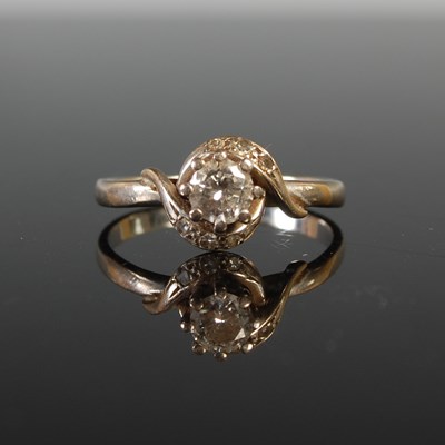 Lot 45 - A white metal and diamond set cross-over style...