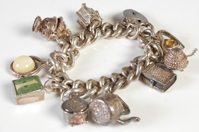Lot 87 - A vintage silver charm bracelet with heart...