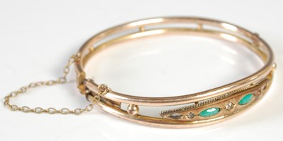 Lot 494 - A gold plated green and clear gemstone set...